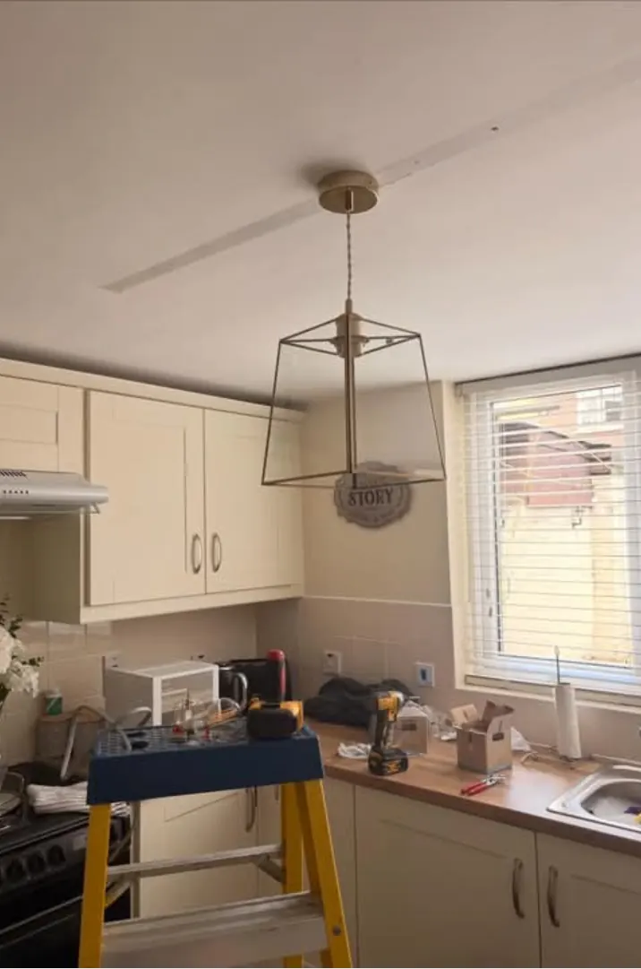 Kitchen with a new open-frame pendant light hanging over the worktop