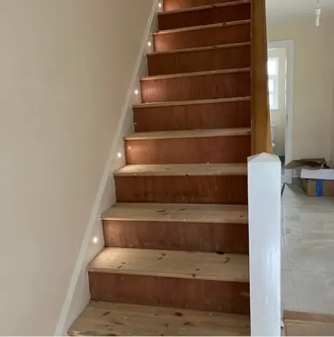 Staircase with small lights set into the wall beside the steps